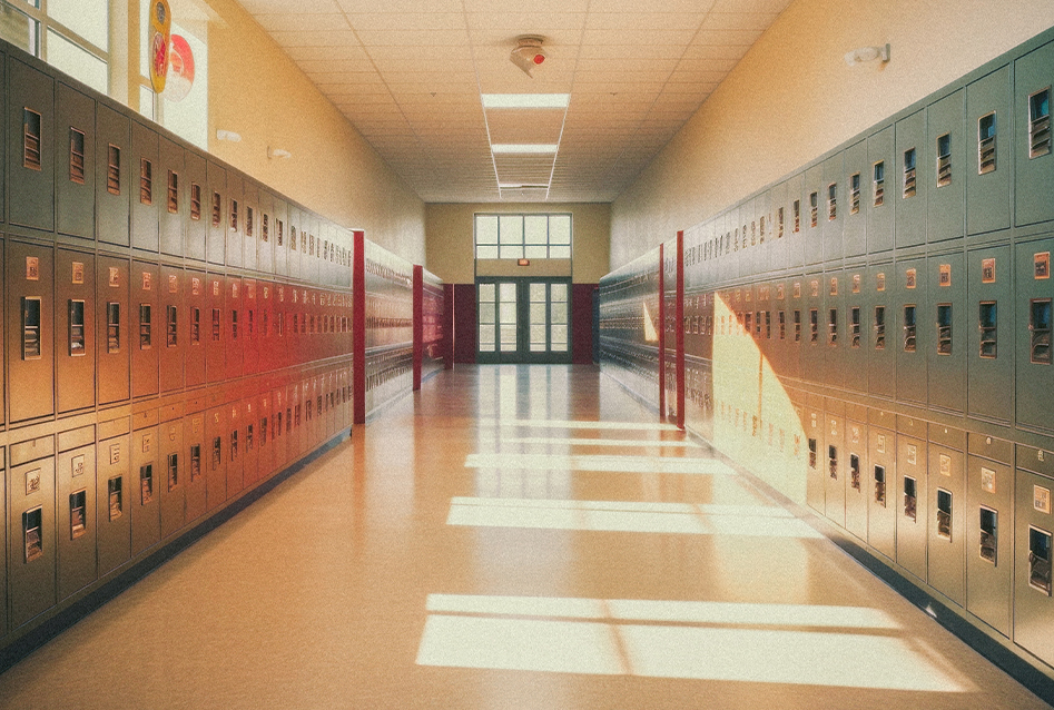 school-night-hero Rows of lockers in a sunlit school hallway, set for back to school night.